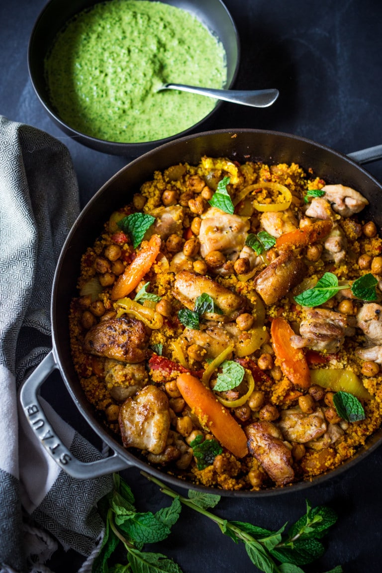 A delicious Tunisian-inspired Chicken Tagine (or sub chickpeas) with couscous, carrots, and flavorful Green Harissa Sauce. A one-pan meal that can be made in 45 minutes! Vegan and Gluten-free adaptable! 