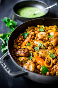 A delicious Tunisian-inspired Chicken Tagine (or sub chickpeas) with couscous, carrots, and flavorful Green Harissa Sauce. A one-pan meal that can be made in 45 minutes! Vegan and Gluten-free adaptable! 