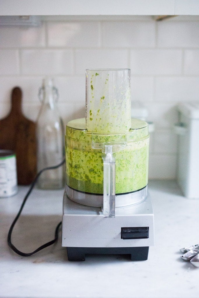 blended green harissa sauce in food processor.