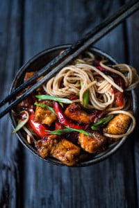 A simple delicious recipe for Kung Pao Noodles that can be made with chicken, tofu, fish, shrimp or veggies, served over noodles with a flavorful Kung Pao Sauce. | www.feasingathome.com