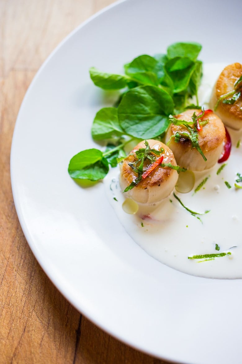 Seared Scallops with fragrant coconut lemongrass sauce, fresh basil and lime zest. FAST, Flavorful and easy to make. A Fresh and healthy recipe! | www.feastingathome.com