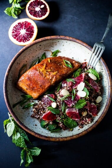 A healthy delicious recipe for Moroccan Salmon, paired with a Quinoa salad with orange, mint, almonds and olives. Simple, fast and easy. | www.feastingathome.com #salmon #detox recipes #paleo #healthy
