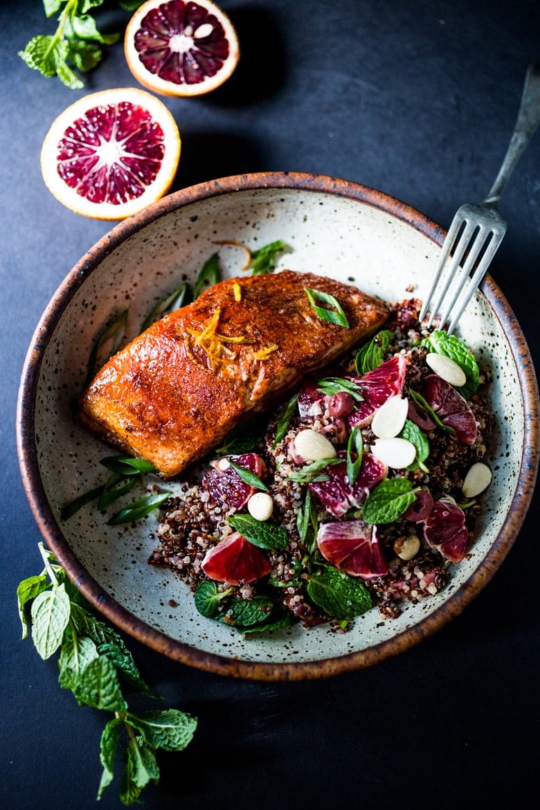 A healthy delicious recipe for Moroccan Salmon, paired with a Quinoa salad with orange, mint, almonds and olives. Simple, fast and easy. | www.feastingathome.com