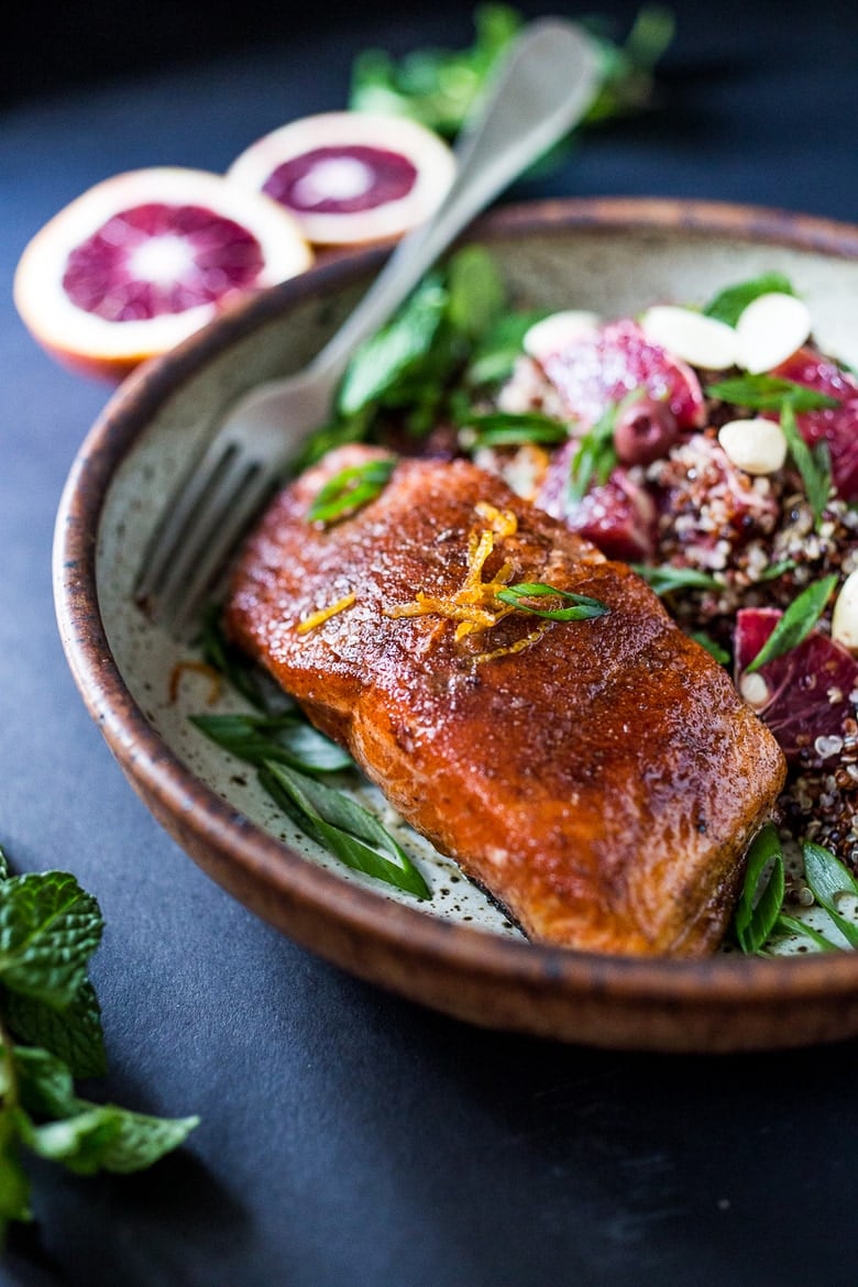 A healthy delicious recipe for Moroccan Salmon, paired with a Quinoa salad with orange, mint, almonds and olives. Simple, fast and easy. | www.feastingathome.com