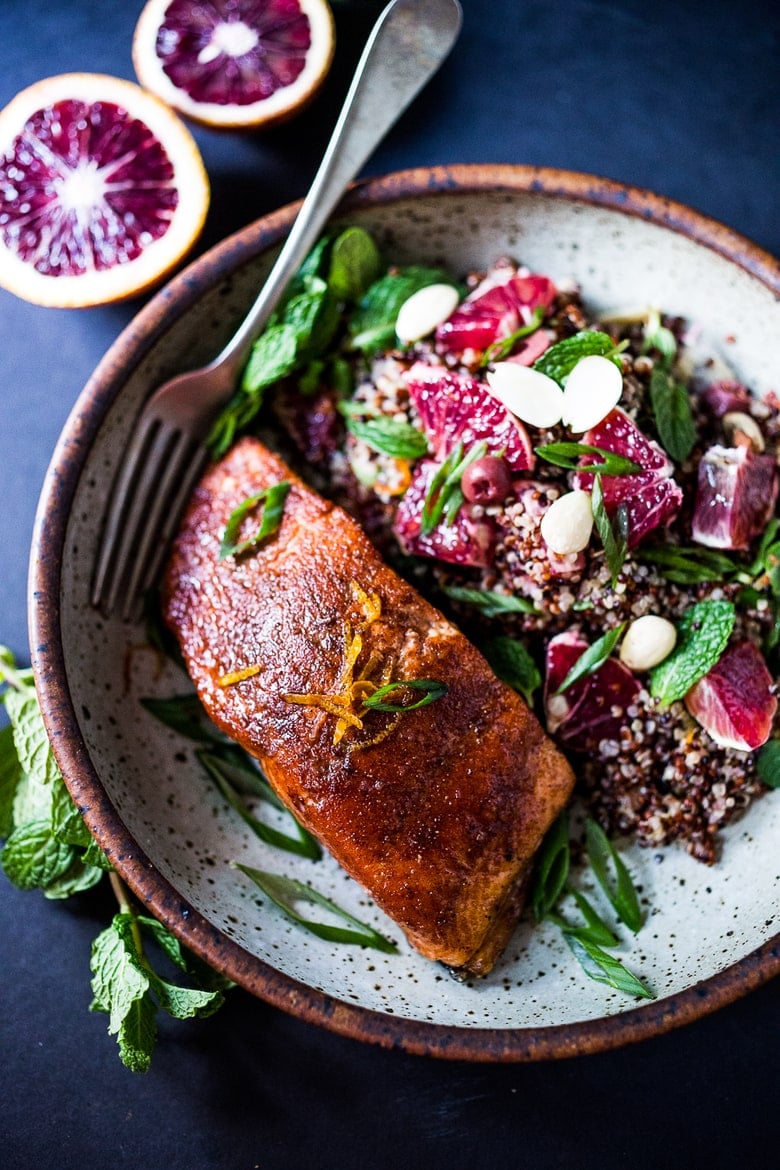 A healthy delicious recipe for Moroccan Salmon, paired with a Quinoa salad with orange, mint, almonds and olives. Simple, fast and easy. | www.feastingathome.com