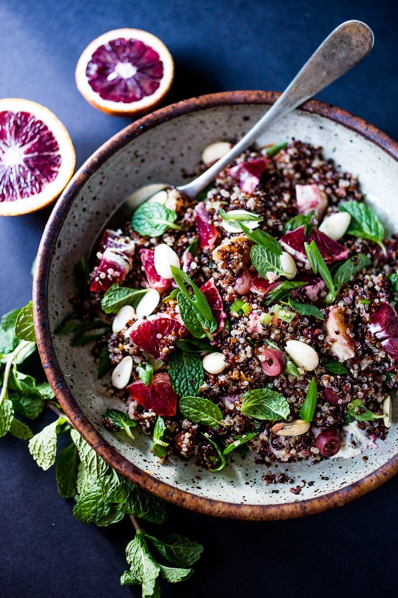 A delicious vegan Moroccan Salad with blood oranges, quinoa, almonds, olives, mint and a tangy, bright blood orange dressing. Perfect for the holiday table, this salad is festive and healthy! | #moroccansalad #bloodorange #bloodorangesalad #quinoasalad #vegansalad #holidaysalad #vegan #healthysalad www.feastingathome.com