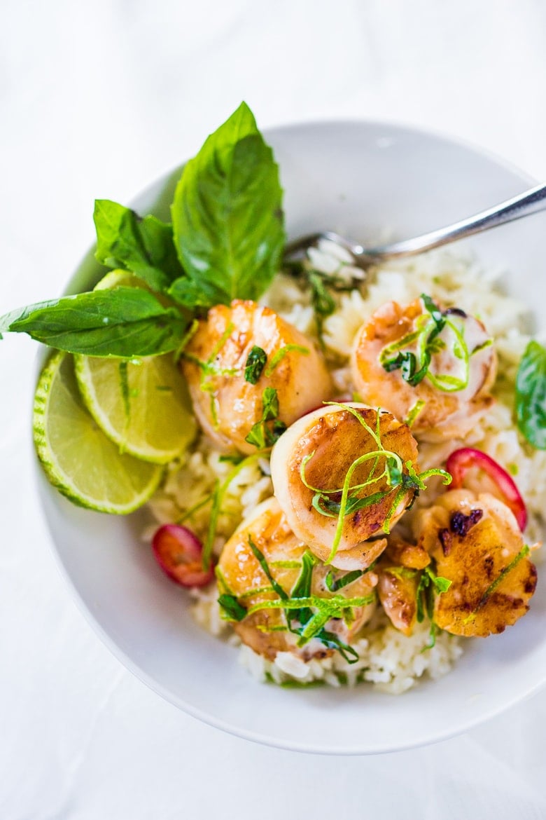 Seared Scallops with fragrant coconut lemongrass sauce, fresh basil and lime zest. FAST, Flavorful and easy to make. A Fresh and healthy recipe! | www.feastingathome.com