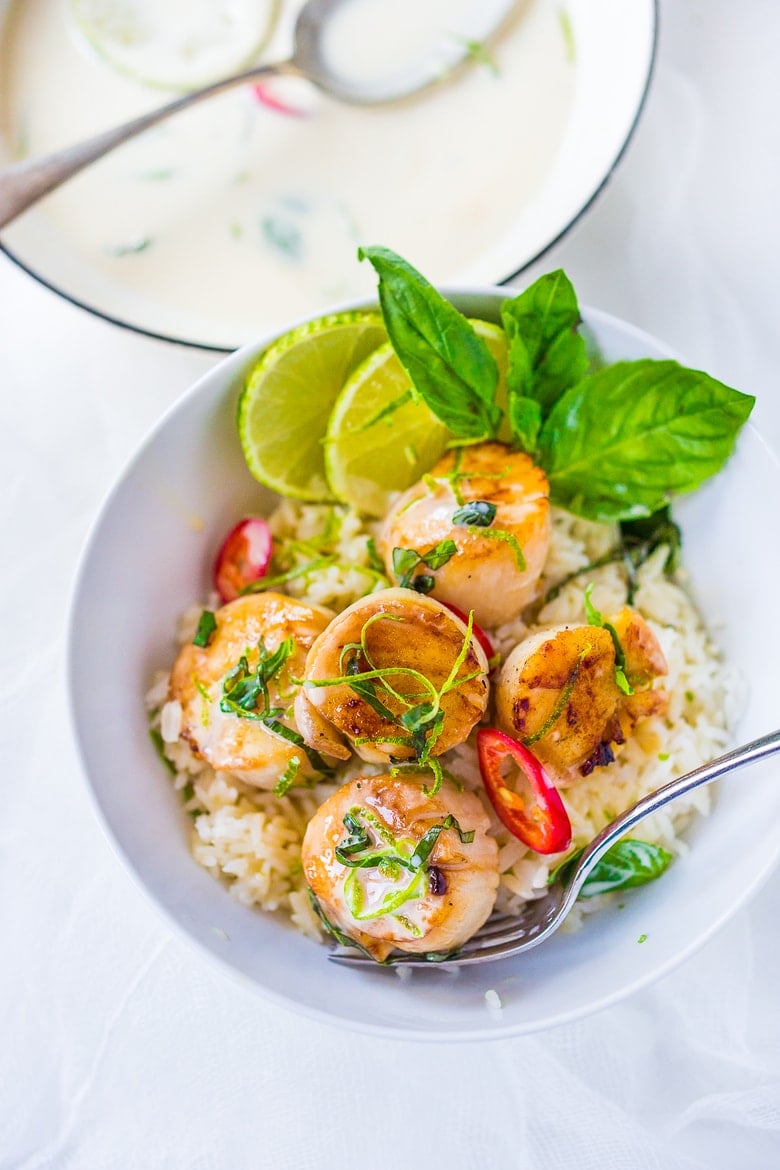 Seared Scallops with fragrant coconut lemongrass sauce, fresh basil and lime zest. FAST, Flavorful and easy to make. A Fresh and healthy recipe! | www.feastingathome.com