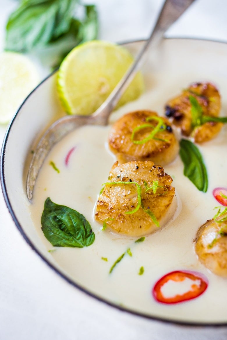 Seared Scallops with fragrant coconut lemongrass sauce, fresh basil and lime zest. FAST, Flavorful and easy to make. A Fresh and healthy recipe! | www.feastingathome.com