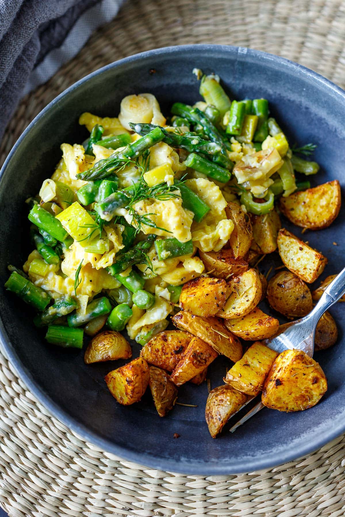This recipe for Scrambled Eggs is made with tender asparagus, melted leeks, chèvre, and fresh dill - is a simple, easy breakfast inspired by spring!