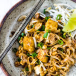 15 MINUTE PAD THAI- an easy, authentic recipe with made with accessible ingredients that can be made with chicken or tofu! Gluten free, Vegan adaptable with Incredible flavor ! | #authenticpadthai #easypadthai #padthai #padthainoodles www.feastingathome.com