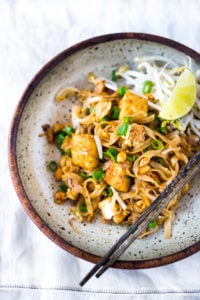 BEST 15 MINUTE PAD THAI- an easy, authentic recipe with made with accessible ingredients that can be made with chicken or tofu! Gluten free, Vegan adaptable with Incredible flavor ! | #authenticpadthai #easypadthai #padthai #padthainoodles www.feastingathome.com