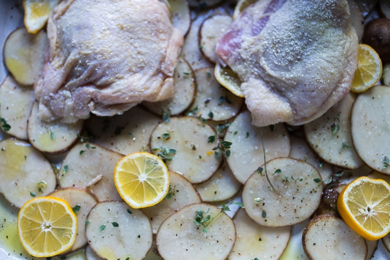 prepping chicken thighs for baking.
