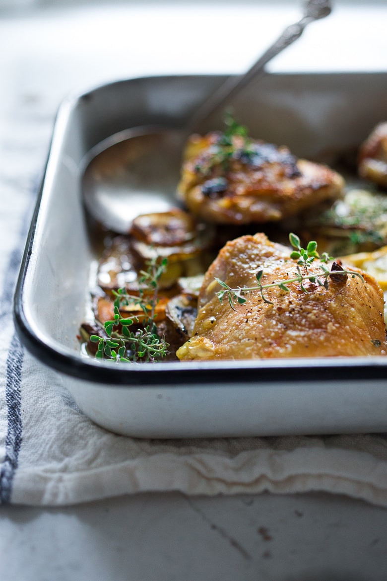 Roasted Chicken Thighs with Lemon, Thyme and Crispy Potatoes. An easy flavorful dinner with just 10 minutes of prep time, before baking in the oven. 