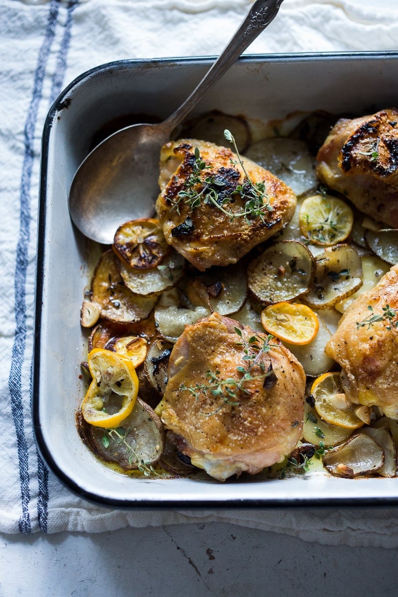 Roasted Chicken Thighs with Lemon, Thyme and Crispy Potatoes. An easy flavorful dinner with just 10 minutes of prep time, before baking in the oven. 
