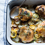 Roasted Chicken Thighs with Lemon, Thyme and Crispy Potatoes. An easy flavorful dinner with just 10 minutes of prep time, before baking in the oven.