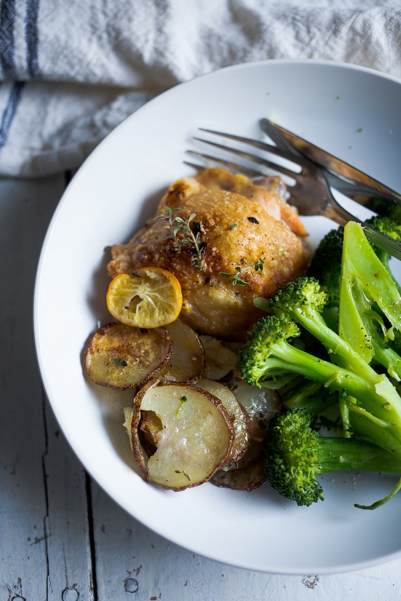 An EASY delicious recipe for One-Pan Chicken and Crispy Potatoes infused with fresh thyme, lemon, and garlic. 10 minutes of prep, then just bake! | www.feastingathome.com