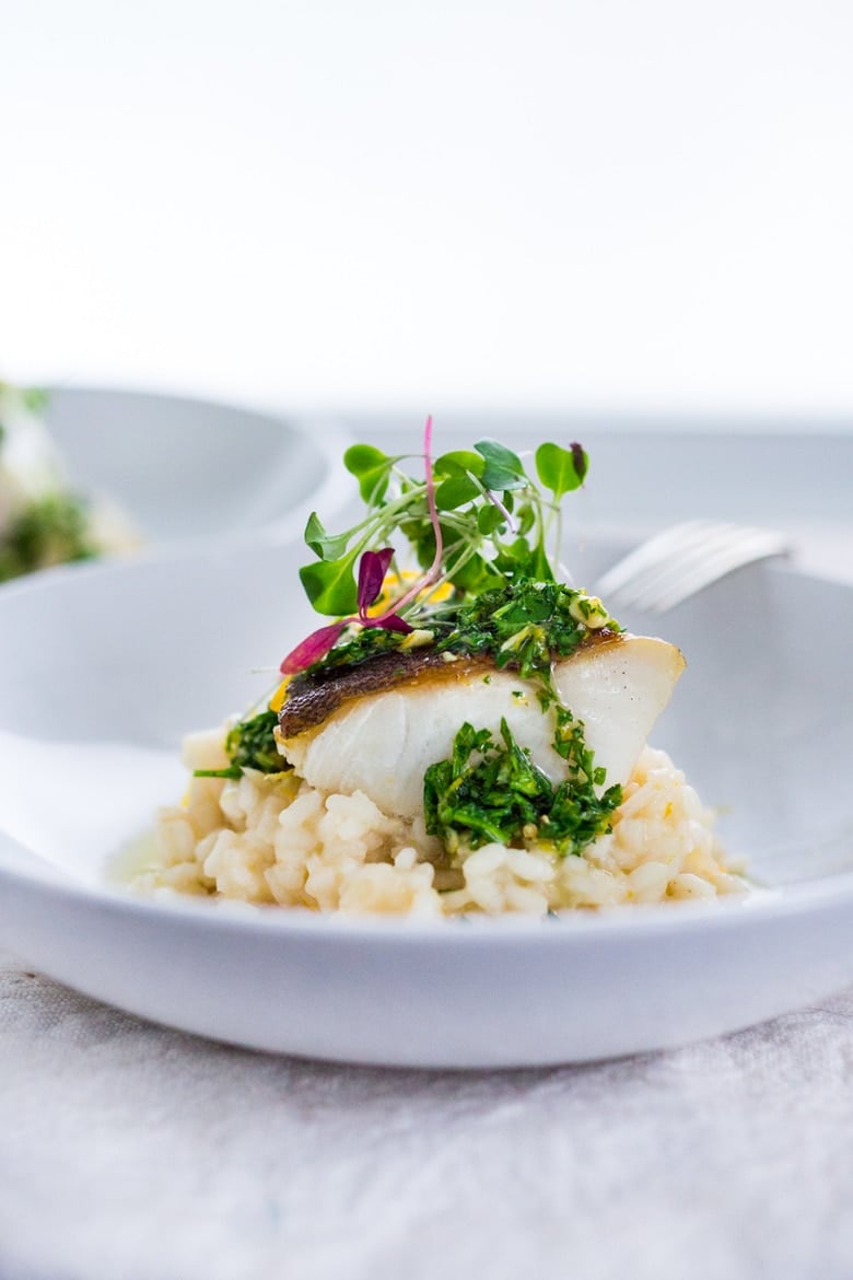 A simple delicious recipe for Seared Black Cod (or halibut, sea bass or scallops) served atop a lightened up Meyer Lemon Risotto drizzled with  Gremolata.  A perfect date-night dinner! 