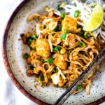 Best Easy PAD THAI- an easy, authentic recipe with made with accessible ingredients that can be made with chicken or tofu! Gluten free, Vegan adaptable with Incredible flavor ! | #authenticpadthai #easypadthai #padthai #padthainoodles www.feastingathome.com