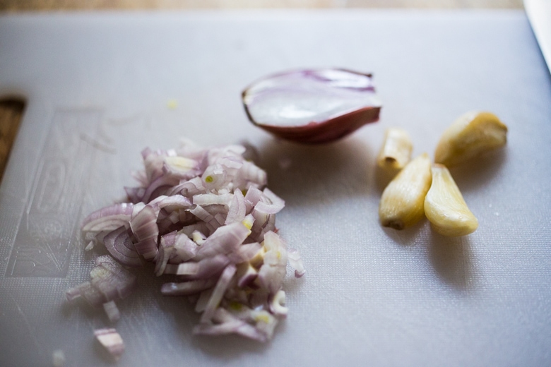 shallots and garlic being chopped.