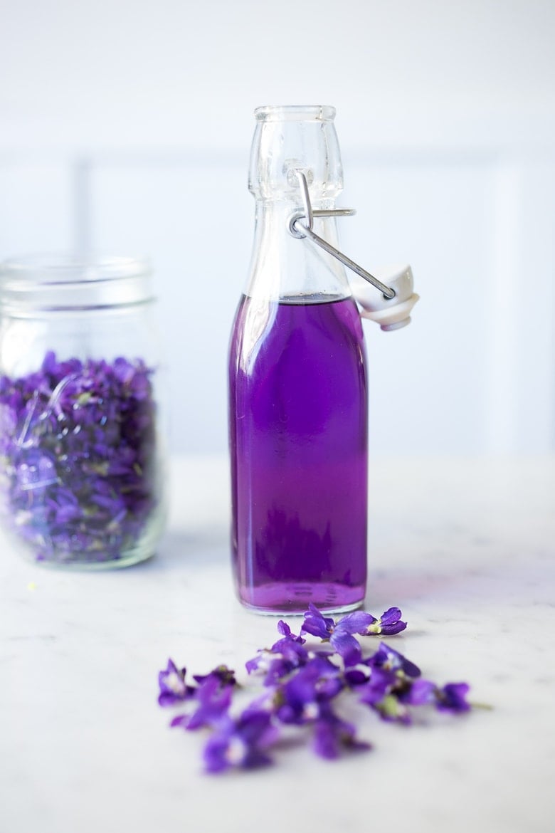 An easy recipe for Violet Simple Syrup- lovely in cocktails like a Violet infused French 75 - perfect for Mothers Day, Bridal Showers or Weddings. Romantic, floral, feminine. | www.feastingathome.com