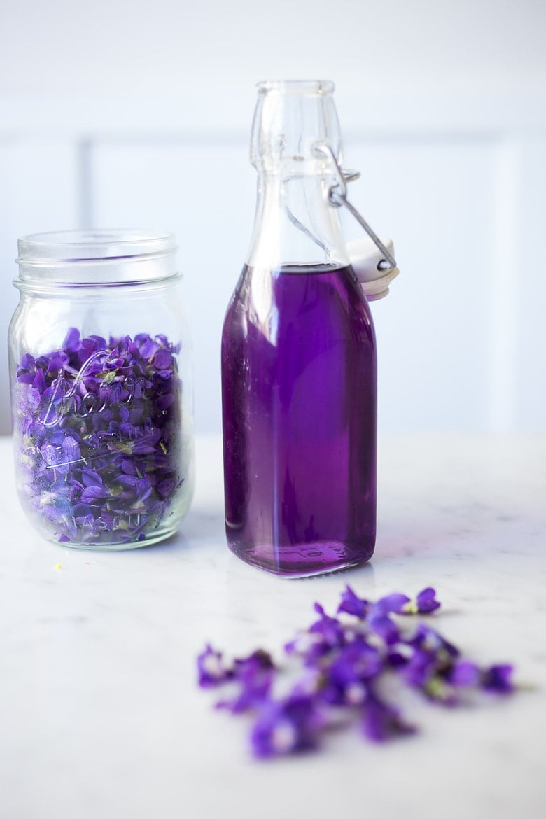 An easy recipe for Violet Simple Syrup- lovely in cocktails like a Violet infused French 75 - perfect for Mothers Day, Bridal Showers or Weddings. Romantic, floral, feminine. | www.feastingathome.com