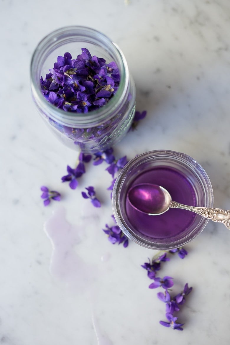 An easy recipe for Violet Simple Syrup- lovely in cocktails like a Violet infused French 75 - perfect for Mothers Day, Bridal Showers or Weddings. Romantic, floral, feminine. | www.feastingathome.com