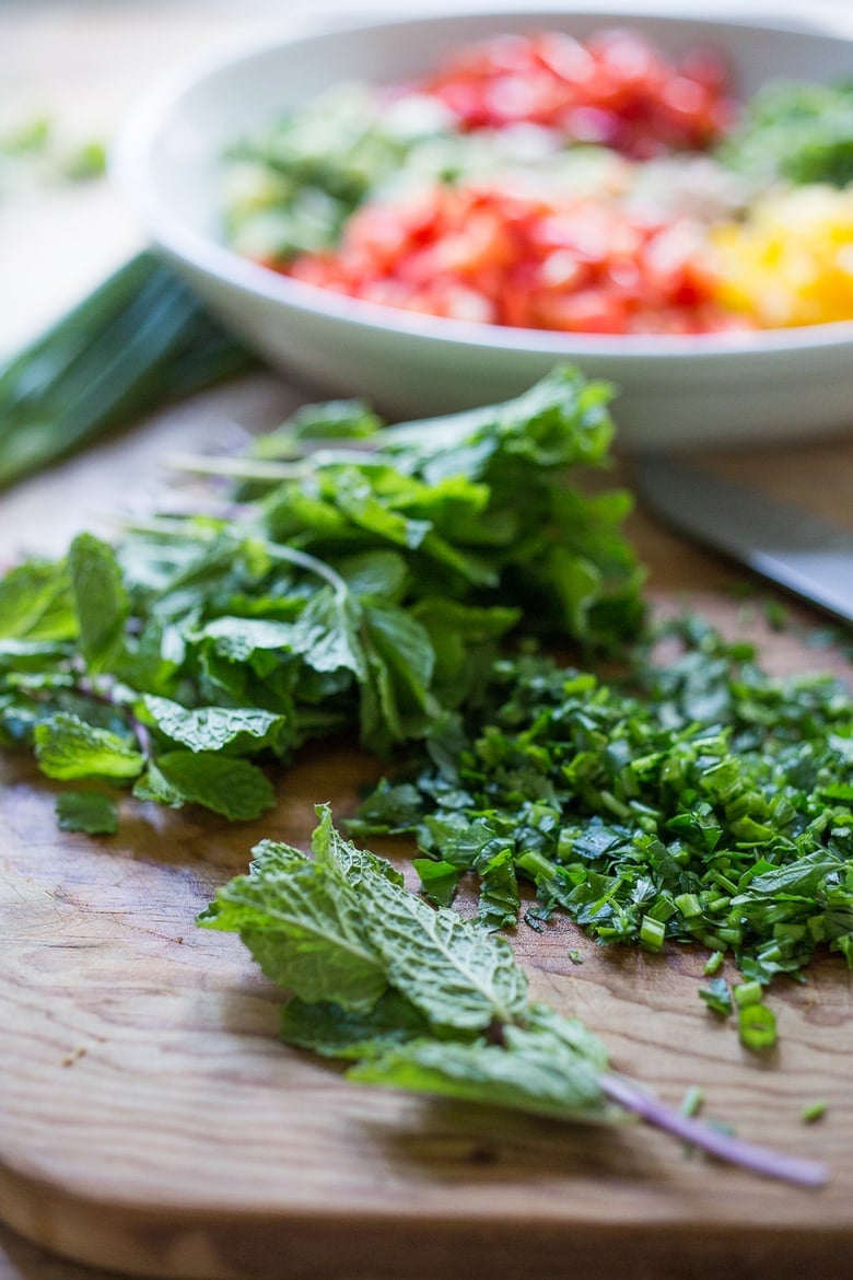 A simple & delicious recipe for Balela Salad, made w/ finely chopped vegetables, chickpeas, fresh herbs, lemon & olive oil. Serve in a pita with tahini sauce or over greens. | www.feastingathome.com