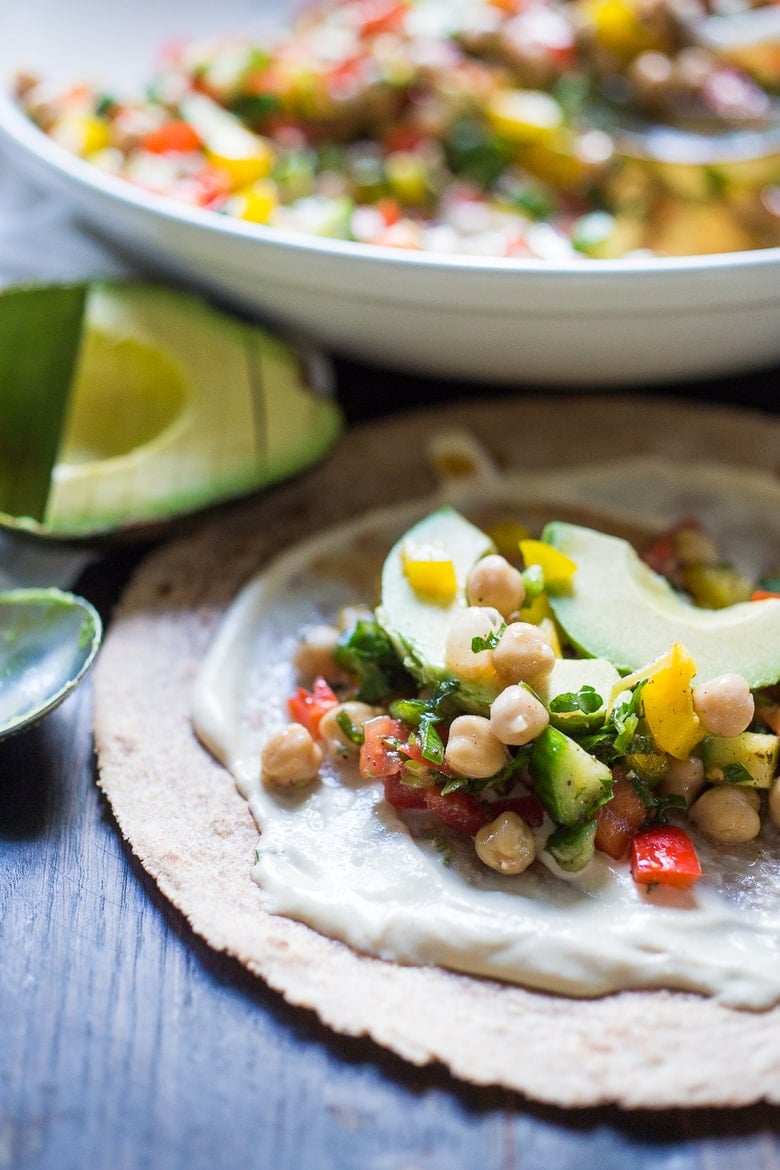 A simple & delicious recipe for Balela Salad, made w/ finely chopped vegetables, chickpeas, fresh herbs, lemon & olive oil. Serve in a pita with tahini sauce or over greens. | www.feastingathome.com