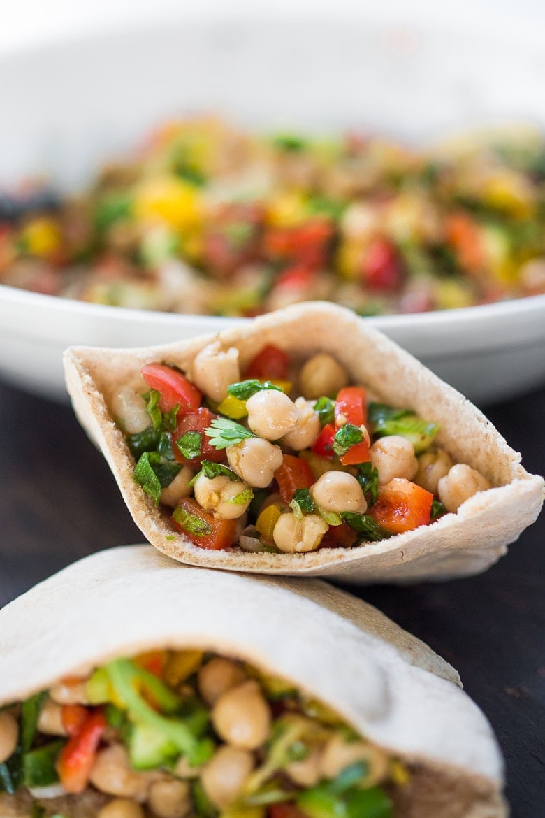 A simple & delicious recipe for Balela Salad, made w/ finely chopped vegetables, chickpeas, fresh herbs, lemon & olive oil. Serve in a pita with tahini sauce or over greens. | www.feastingathome.com