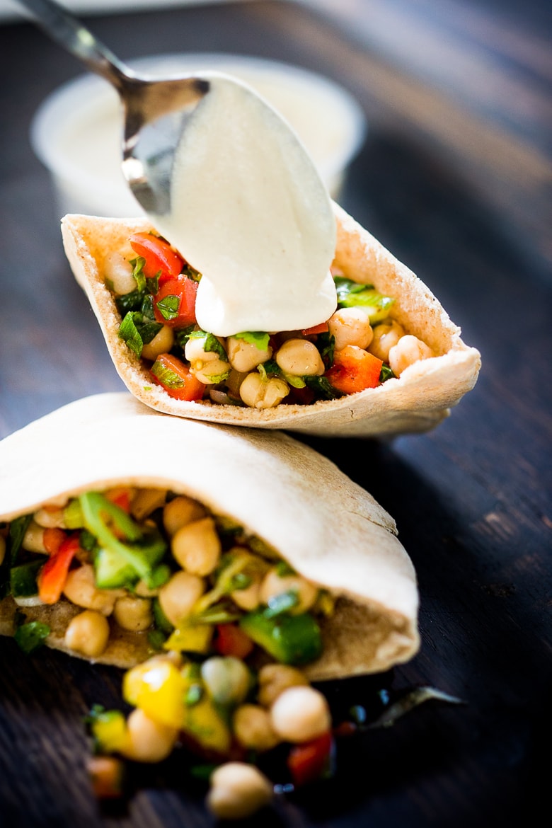 A simple & delicious recipe for Balela Salad, made w/ finely chopped vegetables, chickpeas, fresh herbs, lemon & olive oil. Serve in a pita with tahini sauce or over greens. | www.feastingathome.com