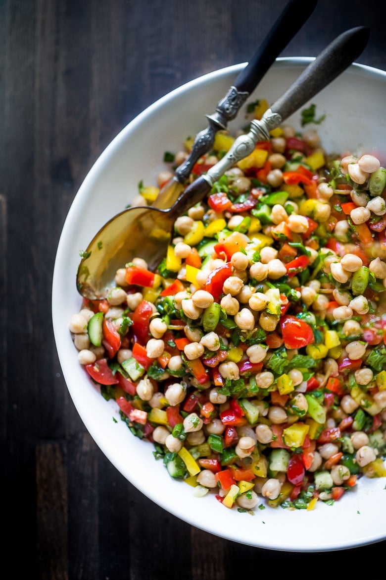 This Middle Eastern Chickpea Salad called Balela Salad, is vegan and healthy! Made w/ finely chopped veggies, fresh herbs, lemon & olive oil. Serve it in a pita with tahini sauce or over greens. | www.feastingathome.com #chickpeasalad #veganchickpeasalad #balela #balelasalad 