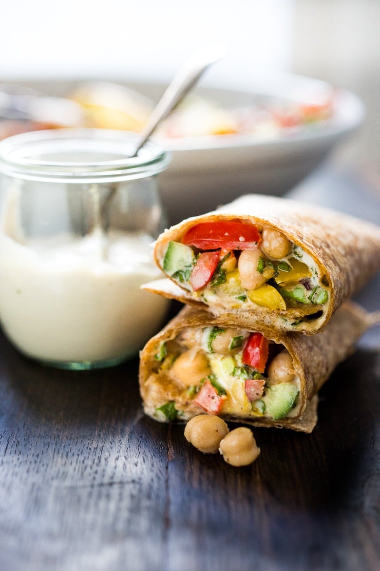 A simple & delicious recipe for a Balela Salad Wrap, made w/ finely chopped vegetables, chickpeas, fresh herbs, lemon & olive oil. Serve in a tortilla with tahini sauce or over greens. | www.feastingathome.com