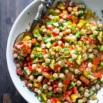 This Middle Eastern Chickpea Salad called Balela Salad, is vegan and healthy! Made w/ finely chopped veggies, fresh herbs, lemon & olive oil. Serve it in a pita with tahini sauce or over greens. | www.feastingathome.com #chickpeasalad #veganchickpeasalad #balela #balelasalad