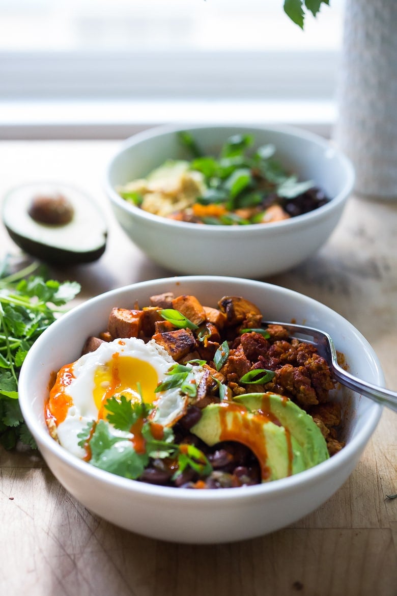 Breakfast Bowls with sweet potatoes, blackbeans, turkey chorizo ( optional) avocado, cilantro and an egg. | www.feastingathome.com