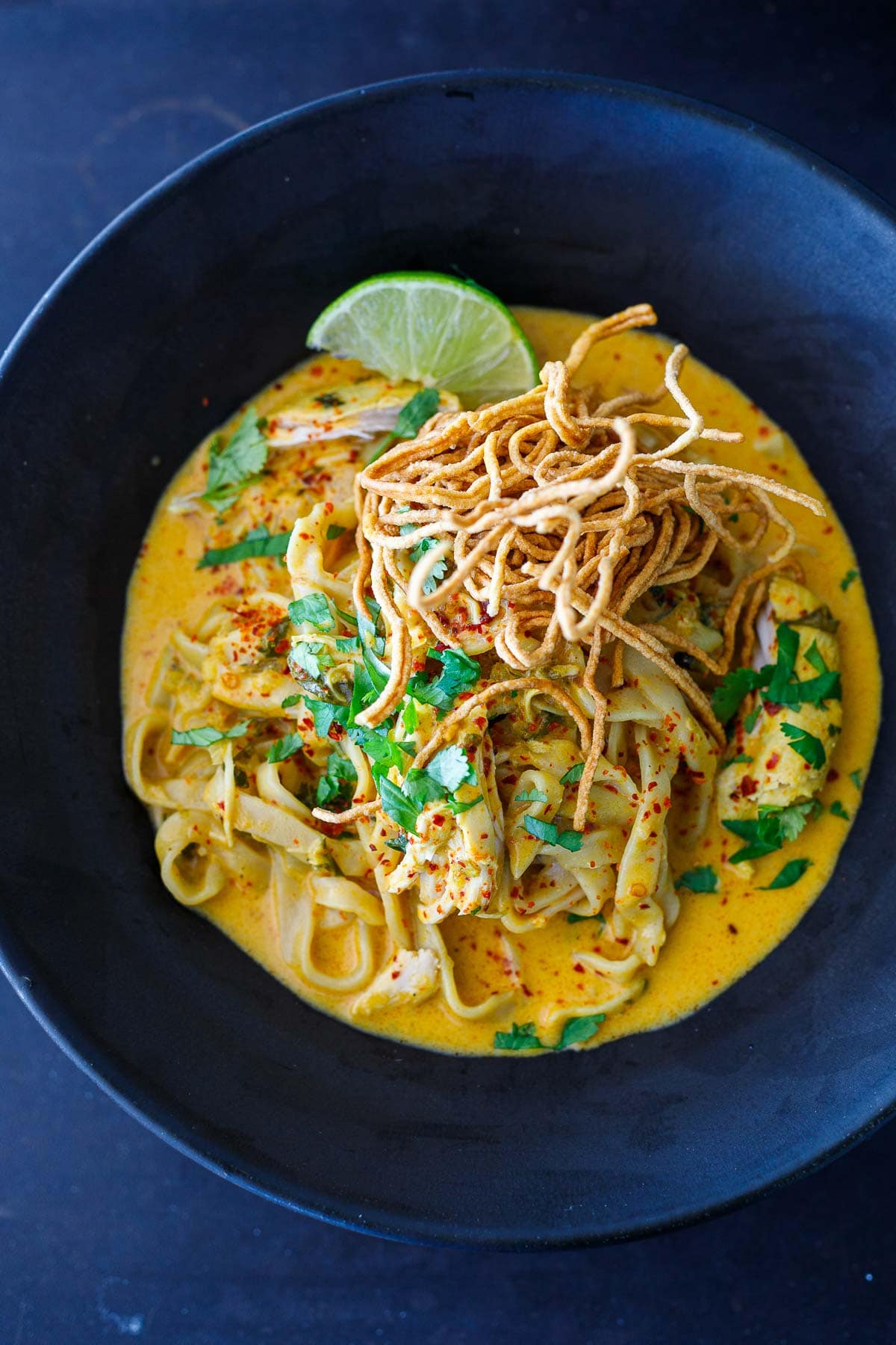 This Khao Soi recipe is rich, fragrant and delicious! It's a Coconut Curry Noodle Soup that hails from Northern Thailand and can be made with chicken, shrimp, tofu, or our crispy tofu. Vegan-adaptable, GF.