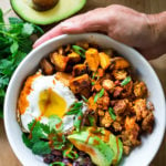 Healthy Yummy Breakfast Bowls with sweet potatoes, blackbeans, turkey chorizo ( optional) avocado, cilantro and an egg. | www.feastingathome.com