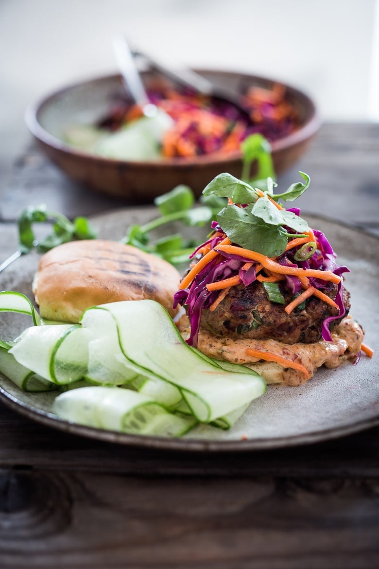 A Delicious recipe for Thai Turkey Burgers- with lemongrass, ginger & basil, topped w/ a Crunchy Asian Slaw and Spicy Aioli. Light, healthy, FLAVORFUL! Easy to make. | www.feastingathome.com #thaiturkeyburger #thaiburger #turkeyburger