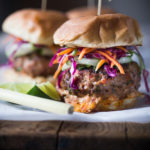 Thai Burgers with Ground turkey, Asian Slaw, Cucumber Ribbons & Spicy Chili Aioli. Light, healthy, Delicious! Easy to make. | www.feastingathome.com #thaiturkeyburger #thaiburger #turkeyburger #asianslaw #carrotslaw #healthyburger