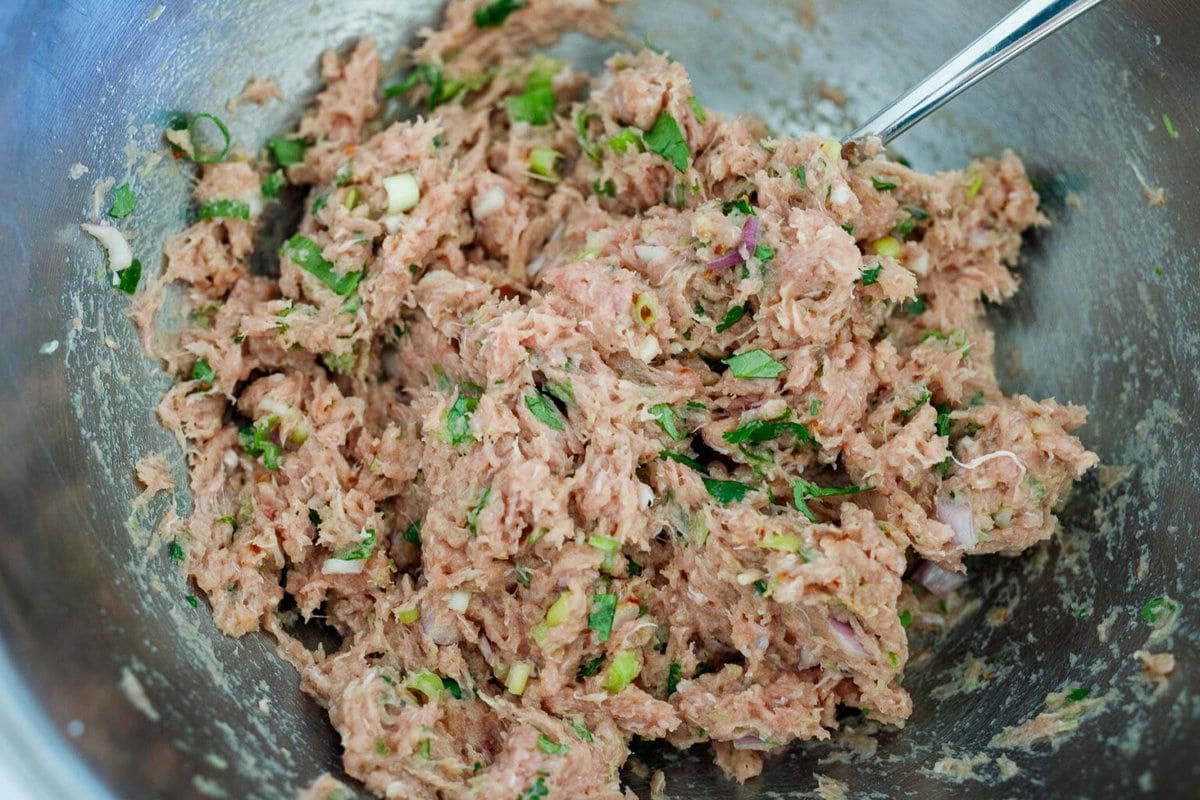 Mixing the turkey burger in a bowl.