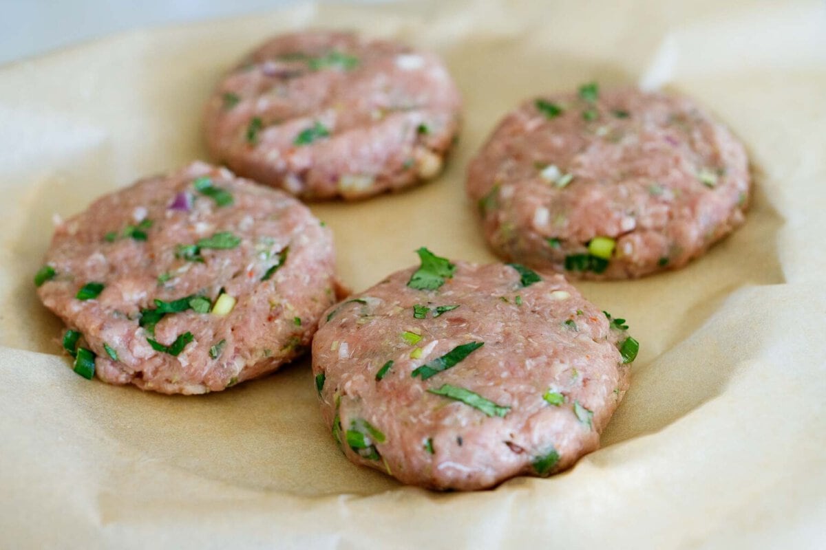 shaping the turkey burgers in to 4 patties, on a plate with parchement.