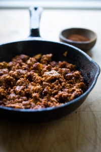 A simple and delicious recipe for Turkey Chorizo - a lightened up version of our favorite Mexican sausage. Can be made in 15 minutes! | www.feastingathome.com