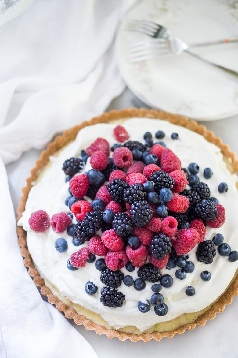 Summer Berry Tart with Shortbread Crust. A simple delicious tart recipe featuring fresh, juicy summer berries, over a lemony filling and a buttery shortbread curst. Easy, delicious! #berrytart #tart #raspberrytart #berries #freshberries #summerdessert #dessert #blackberries 