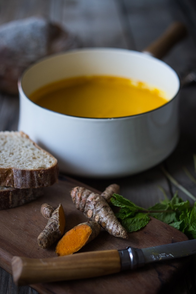A delicious, healthy recipe for Glowing Carrot Turmeric Soup with Coconut Milk and ginger. Fresh turmeric and mint gives this soup its exotic flavor. Vegan. | www.feastingathome.com