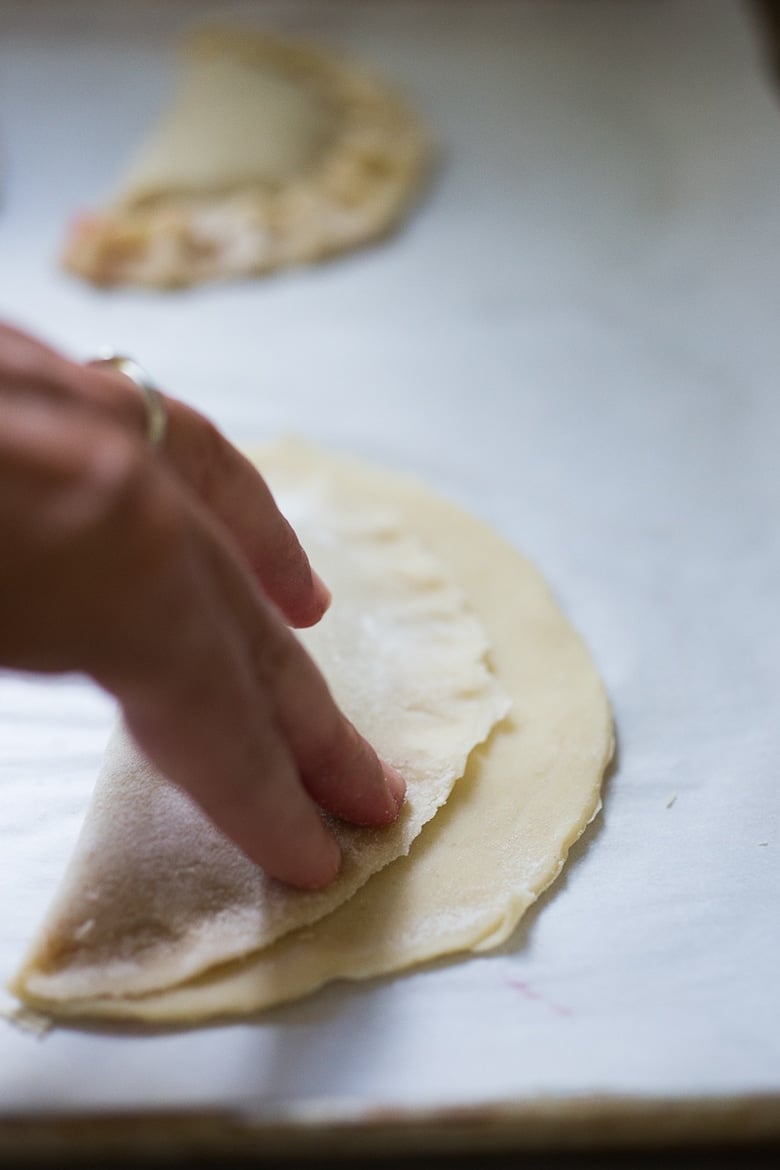 A simple delicious recipe for Strawberry Turnovers or "Hand Pies" , sweetened with maple syrup. Step by step instructions on mastering the "double fold" which prevent the filling from oozing out while baking. | www.feastingathome.com