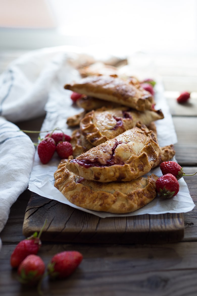 A simple delicious recipe for Strawberry Turnovers (aka "Hand Pies") sweetened with maple syrup! #turnovers #turnoverrecipe #handpies #strawberryrecipes www.feastingathome.com