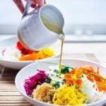 Vegan Sunshine bowl with raw summer roots and Creamy SunflowerSeed Tahini Sauce | www.feastingathome.com