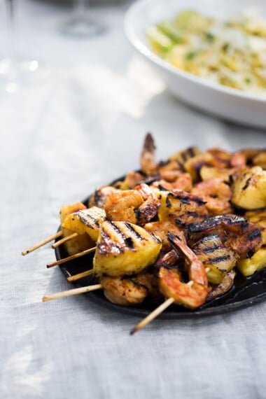 A simple tasty recipe for Grilled Pineapple Chipotle Shrimp Skewers, served with a refreshing Jicama Mango Slaw with cilantro and lime. SO EASY! | www.feastingathome.com