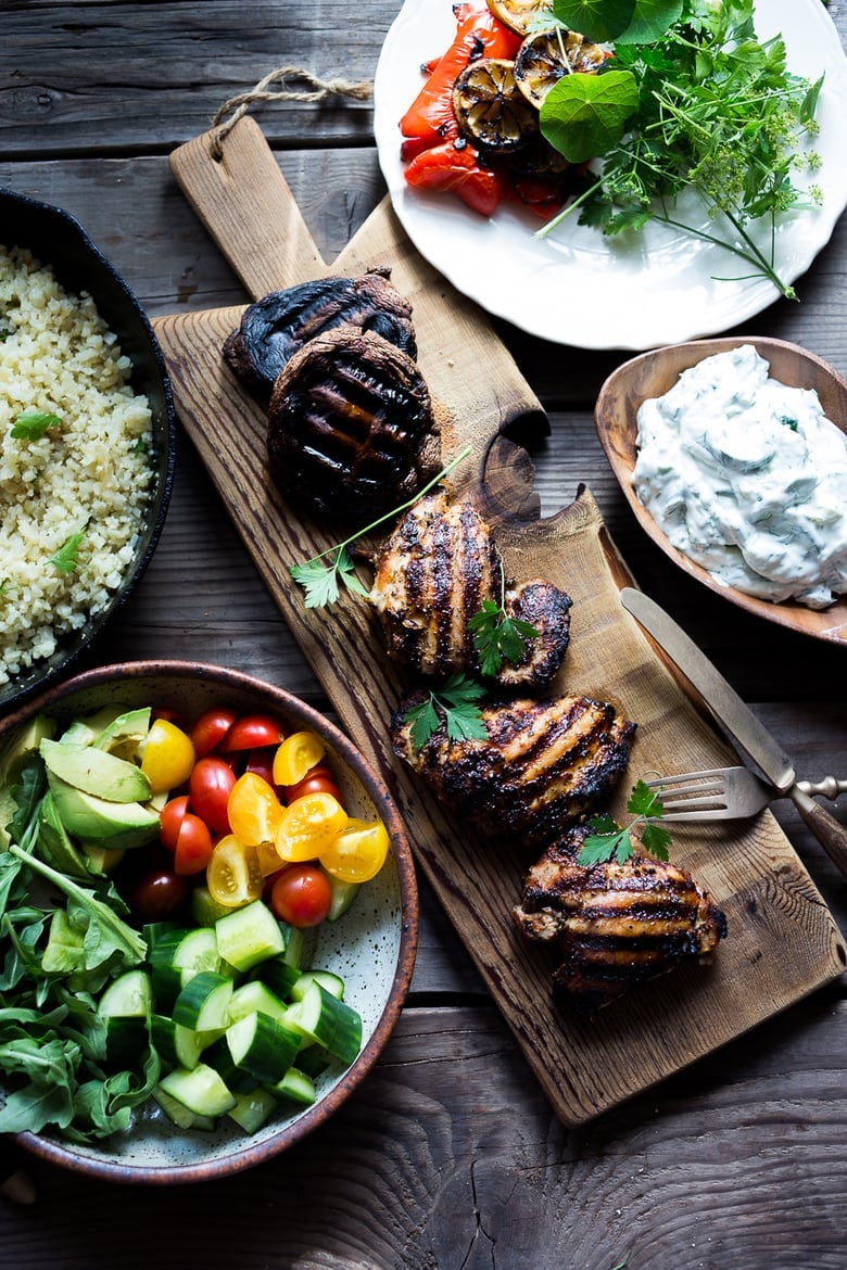 A simple tasty recipe for Grilled Greek Souvlaki Bowl with Cauliflower Rice, flavorful Cucumber Yogurt Sauce and fresh summer vegetables. This can be made with Grilled Chicken or Grilled Portobellos! | www.feastingathome.com