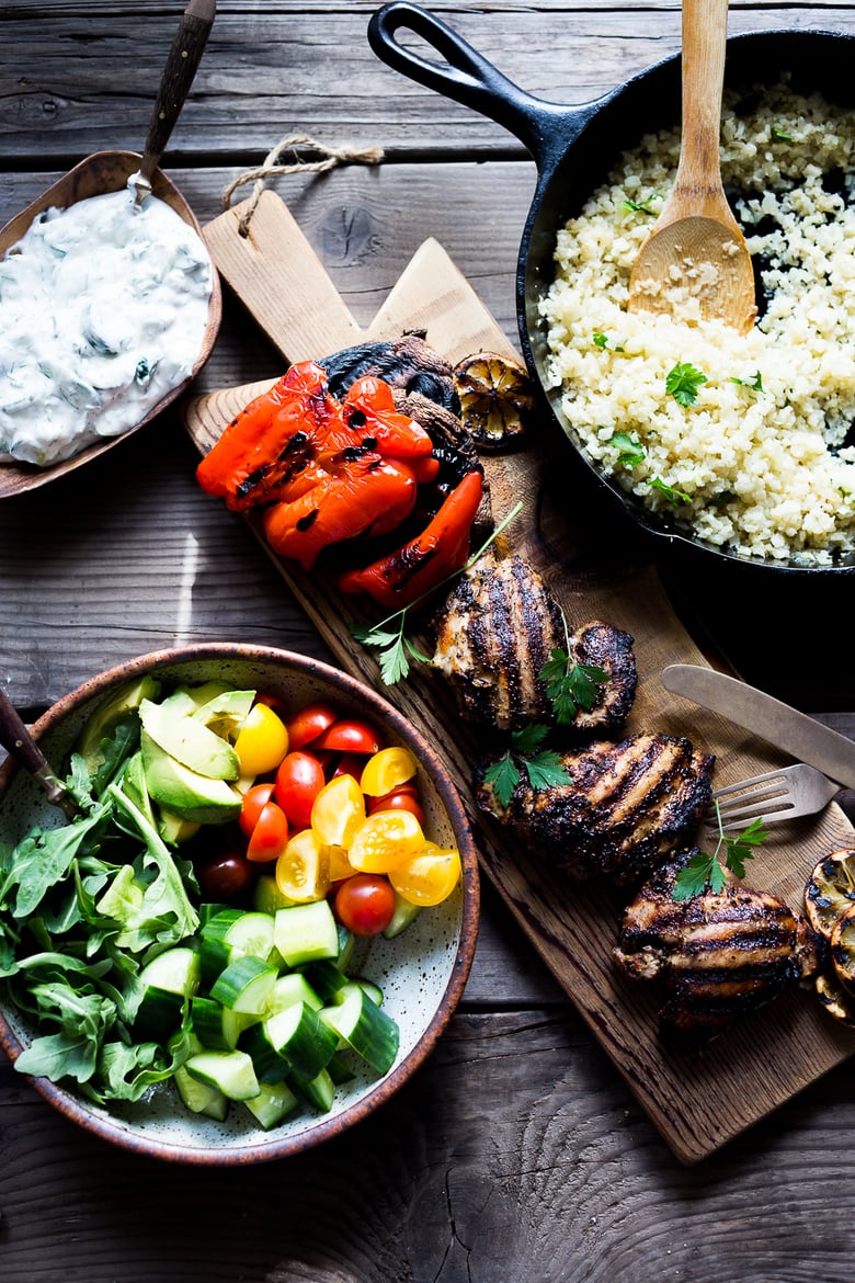 A simple tasty recipe for Grilled Greek Souvlaki Bowl with Cauliflower Rice, flavorful Cucumber Yogurt Sauce and fresh summer vegetables. This can be made with Grilled Chicken or Grilled Portobellos! | www.feastingathome.com